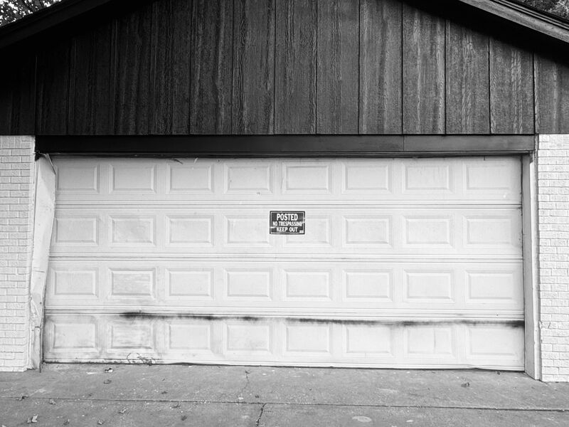 Before: Dented double door replaced with a new navy door