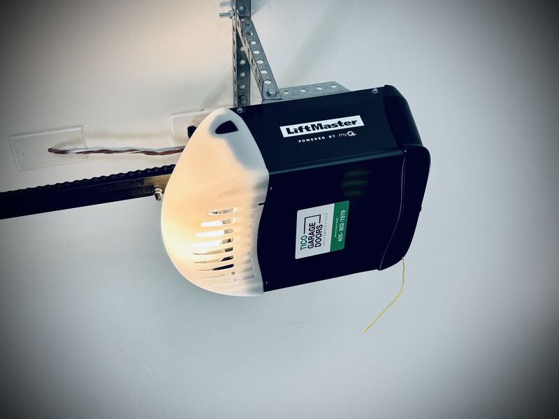 Garage door opener installed by Tico Garage Doors, with the Tico service label