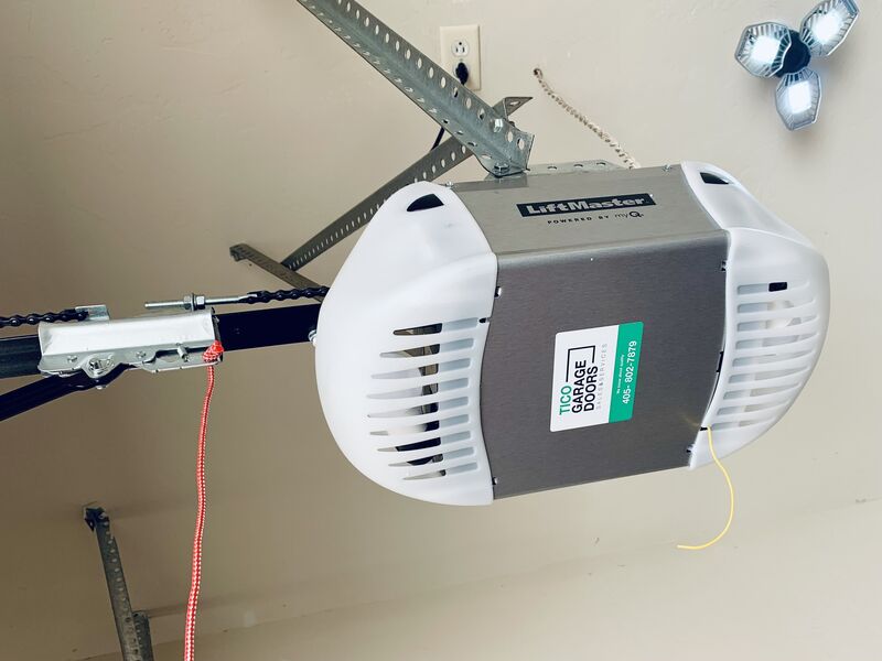 Ceiling-mounted garage door opener with the Tico Garage Doors label